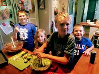 Some camp participants (& their siblings) making dinner for their families.